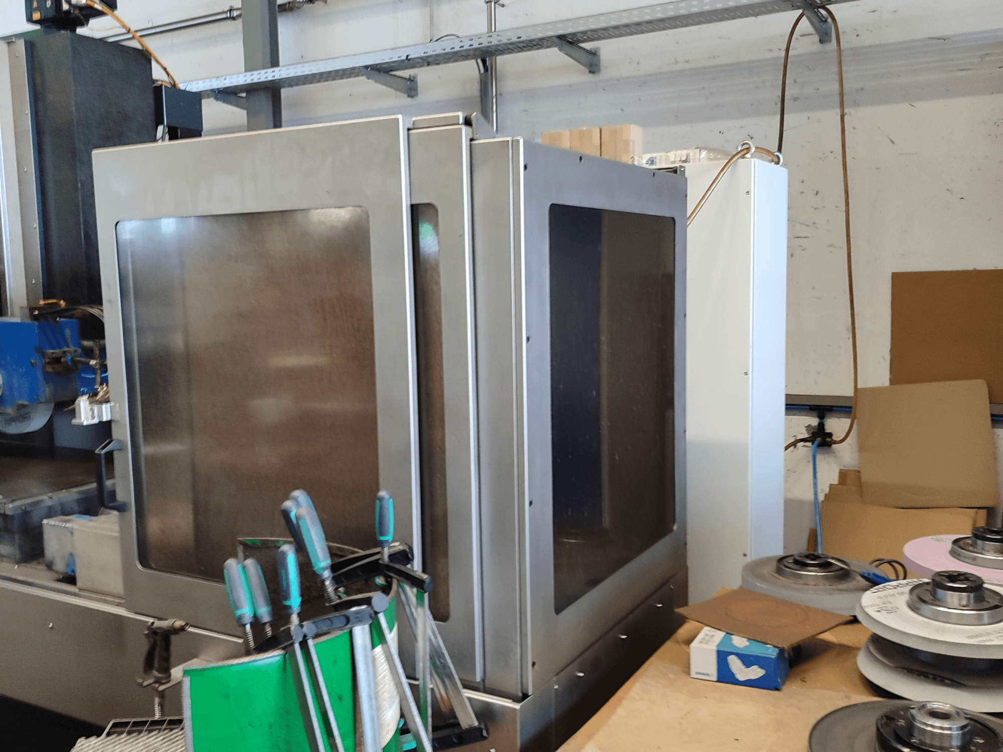 Rectificadora de superfícies HEINZ STÖCKEL FD 1560 NC-T, vista lateral mostrando a caixa metálica e os componentes de retificação em ambiente de oficina.