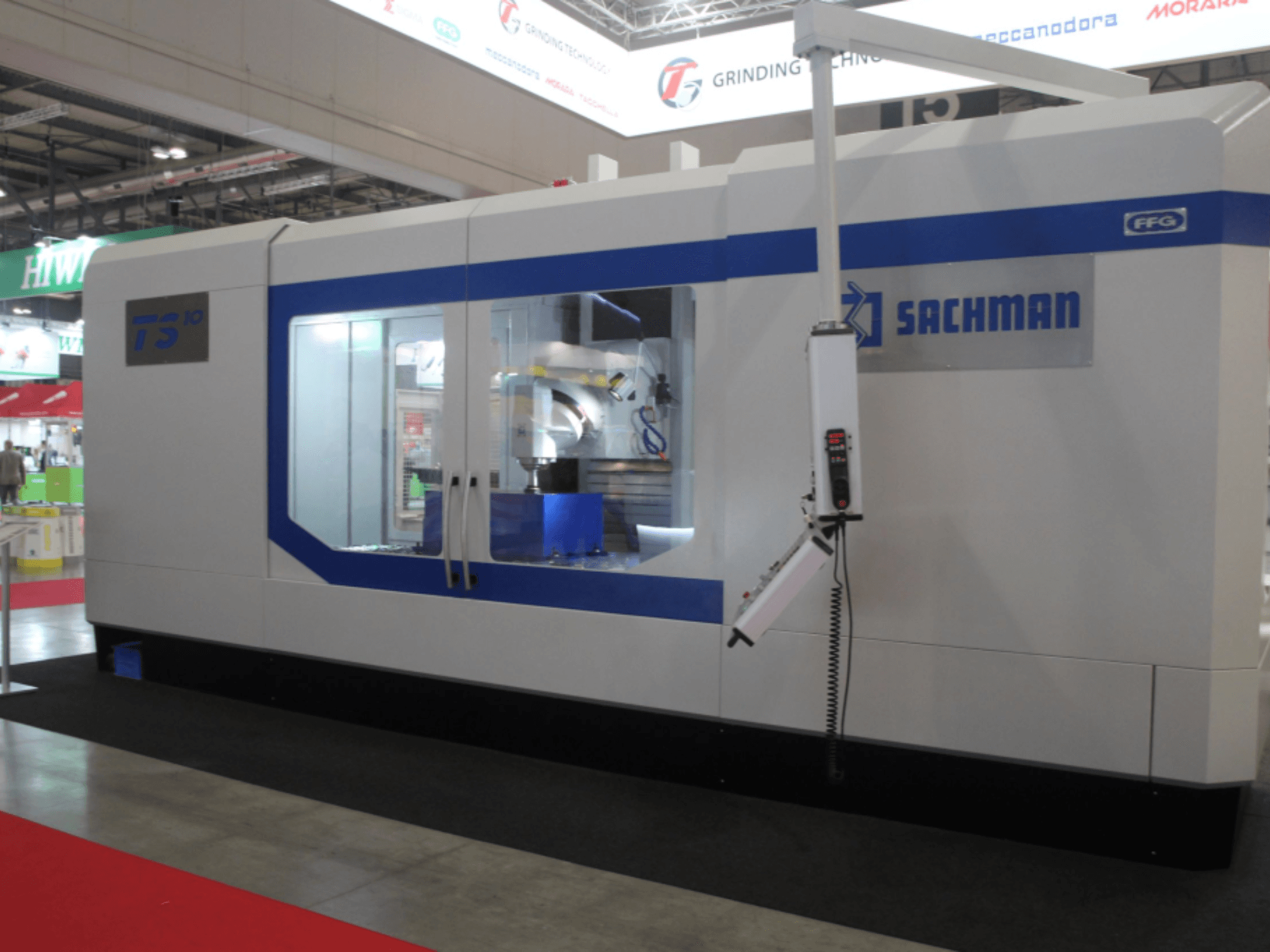 Fresadora SACHMAN TS10 tipo cama, vista frontal, mostrando os controlos, o espaço de trabalho e o design elegante numa feira.