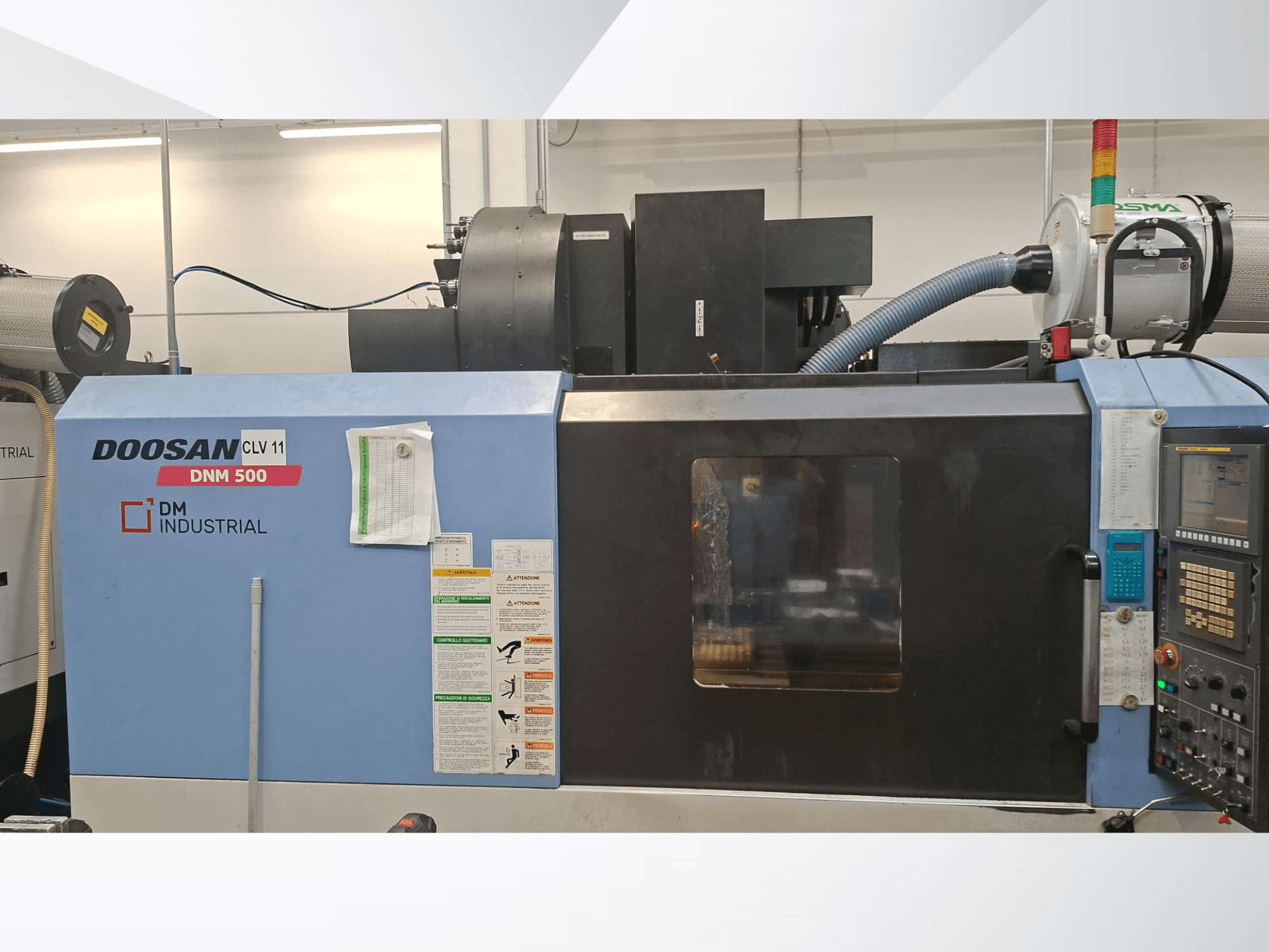 Centro de maquinagem vertical DOOSAN DNM 500, visto de lado, apresentando o painel de controlo e as peças operacionais.