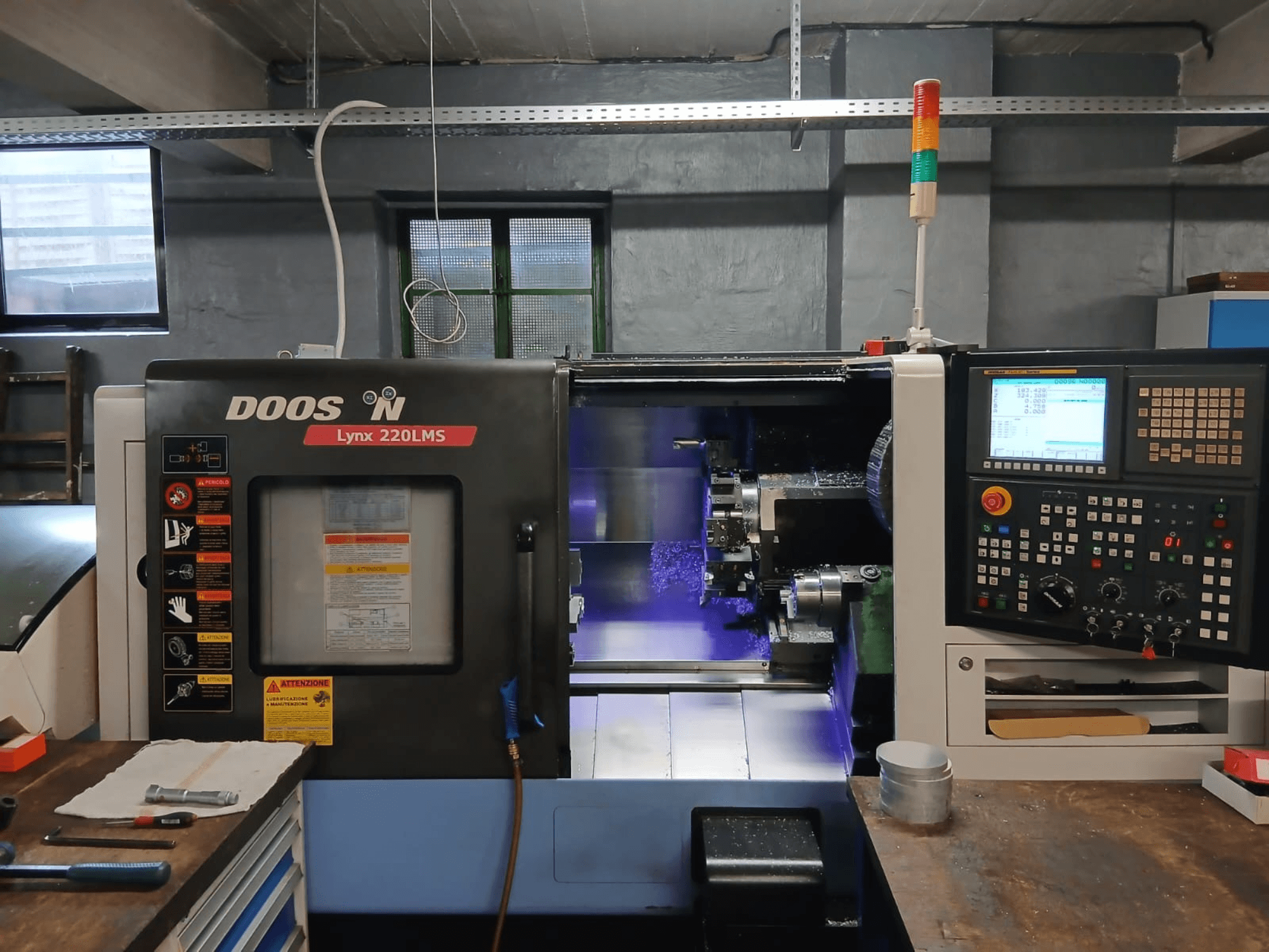 Torno horizontal DOOSAN Lynx 220 LMS, vista frontal, com o painel de controlo e a área de maquinagem visíveis.