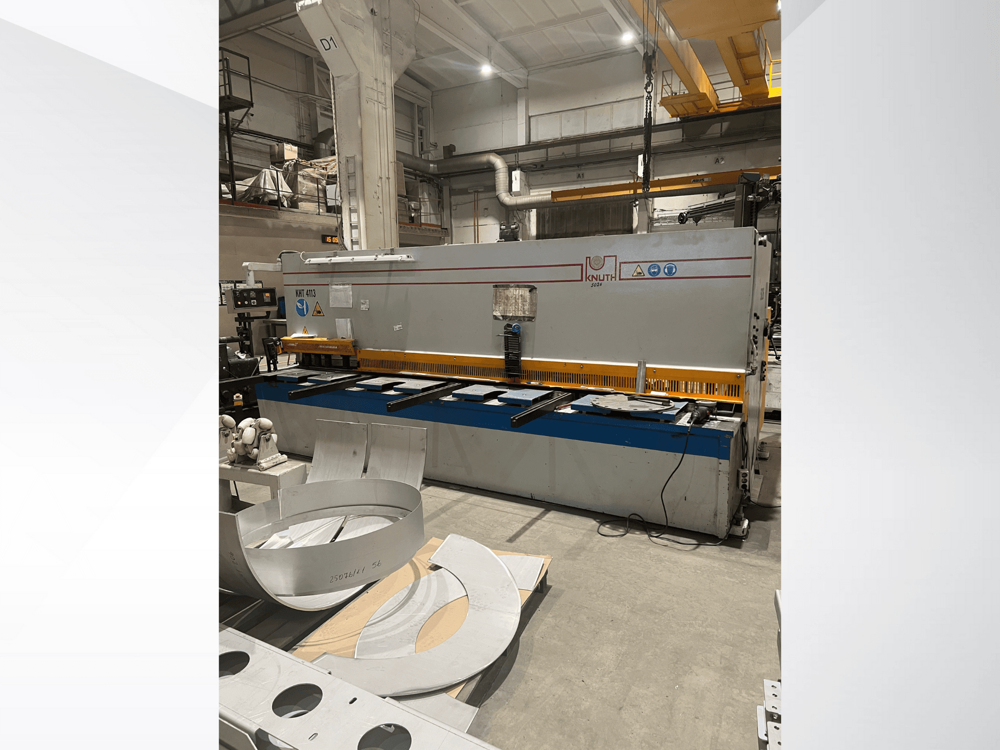 Máquina de corte de chapa Knuth modelo MT 4173 numa oficina, vista frontal mostrando a mesa de corte e as chapas de metal.