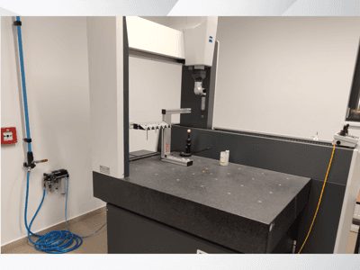 Dispositivo de medição MSR num laboratório, vista frontal mostrando uma mesa de granito, esfera de calibração e utilitários ligados.