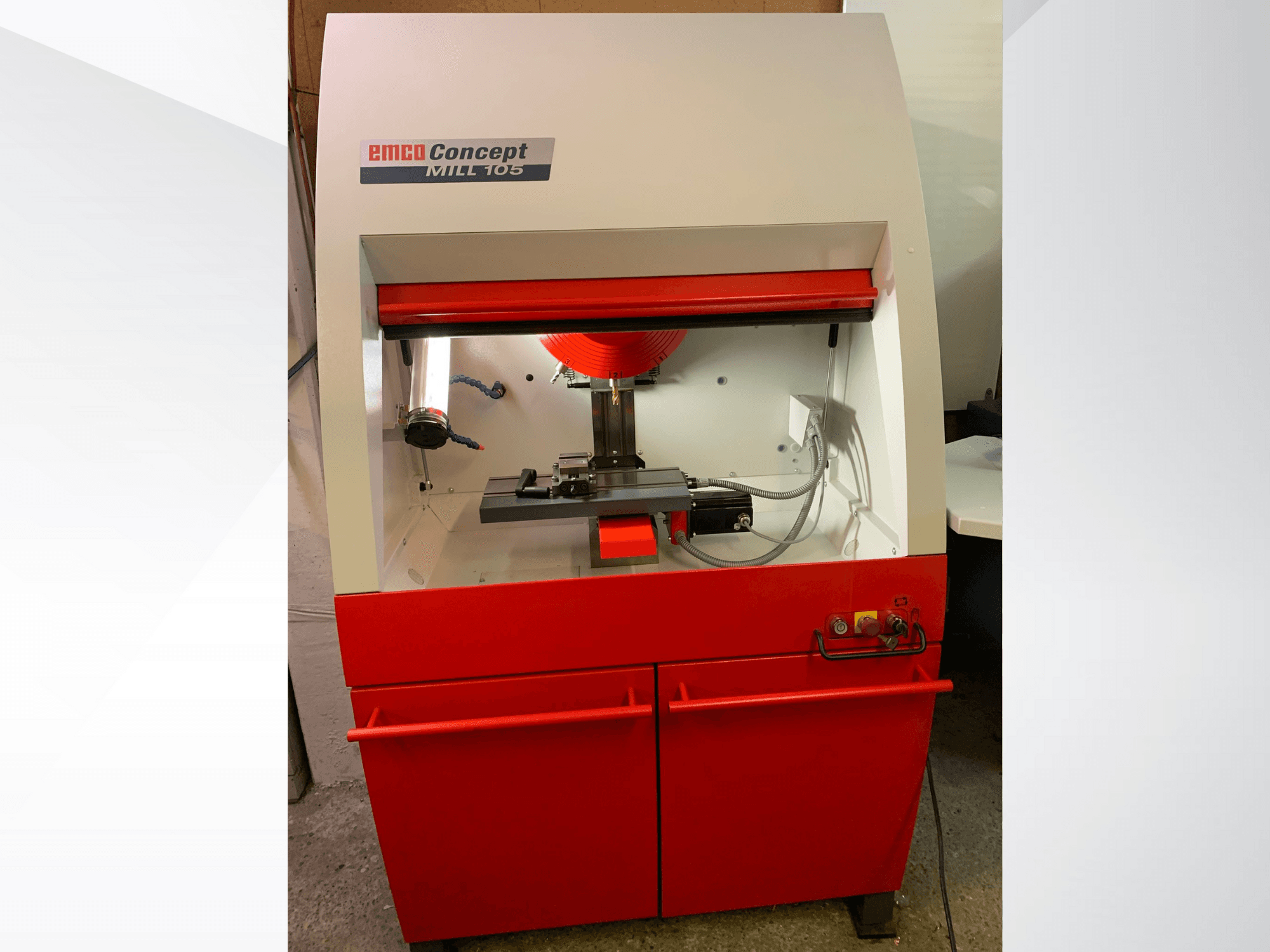 EMCO Concept MILL 105, vista frontal de uma fresadora compacta com uma base vermelha, com uma ferramenta de corte e iluminação brilhante.