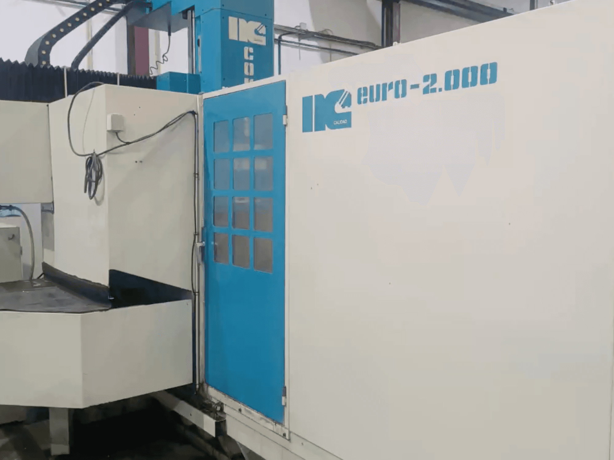 Máquina industrial da IK, modelo Euro-2000, vista de frente, com uma grande mesa de fresagem e um painel de controlo.