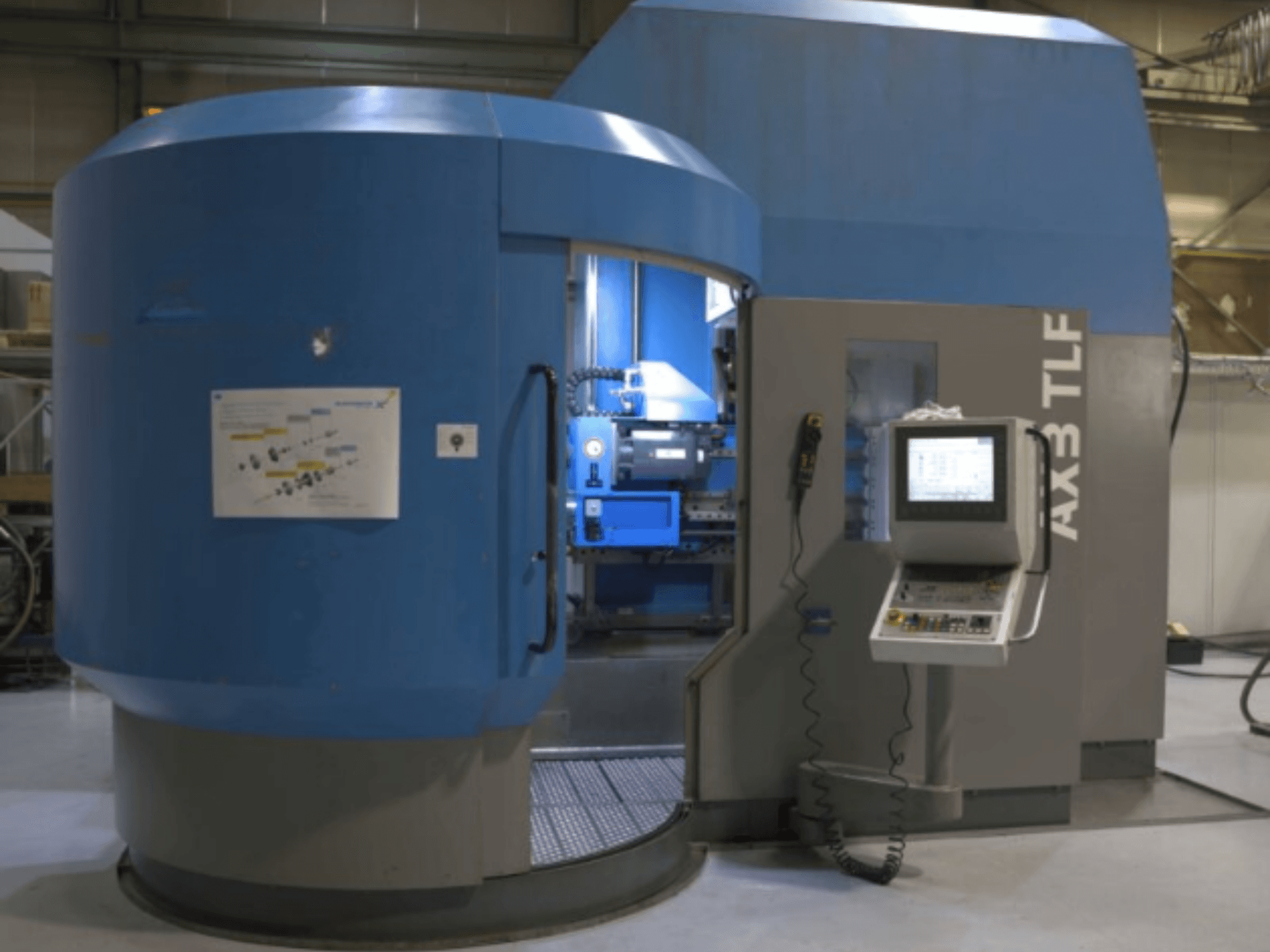 Máquina de perfuração IXION Auerbach IA2 TLF-1200.4 em vista frontal; apresenta painel de controlo e caixa azul.