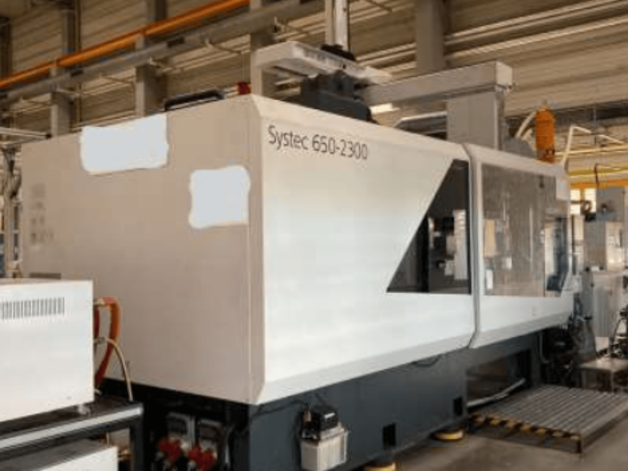 Máquina Systec 660-2300, vista frontal, mostrando o corpo grande, o painel de controlo e a plataforma de carga de segurança, adequada para utilização industrial.