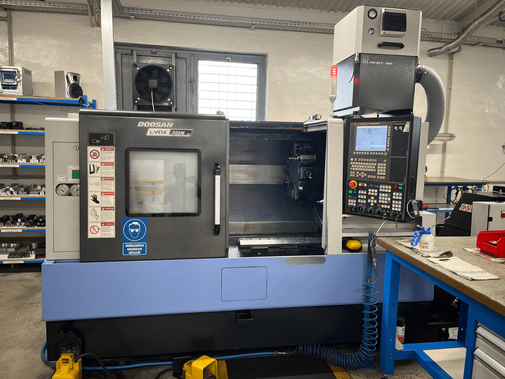 Torno horizontal DOOSAN LYNX 300M, vista frontal, com o painel de controlo e os componentes operacionais.